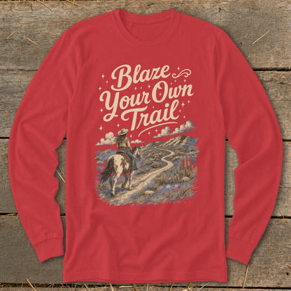Red long-sleeve shirt with "Blaze Your Own Trail" text and equestrian desert landscape graphic.