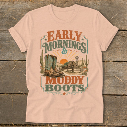 Shirt with "Early Mornings & Muddy Boots" text, boots, barn, and desert scene graphic.