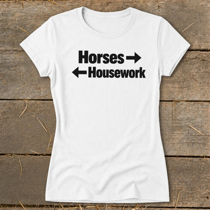 A white t-shirt with black text that reads "Horses" with a right arrow and "Housework" with a left arrow.