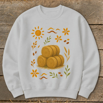 White sweatshirt with a rustic autumn harvest graphic featuring hay bales.