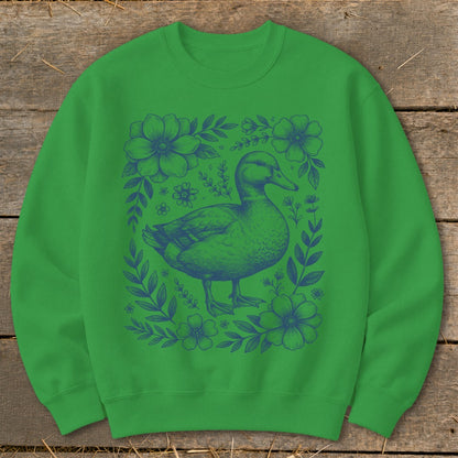 Green sweatshirt with a blue duck surrounded by floral vines.