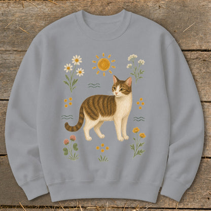 Gray sweatshirt with a brown and white tabby cat surrounded by flowers and a sun.