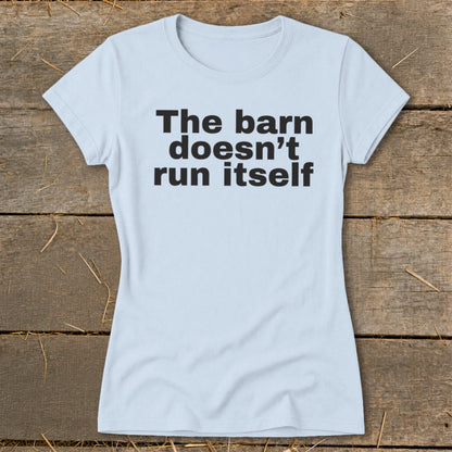 Light blue t-shirt with black text that reads "The barn doesn't run itself".