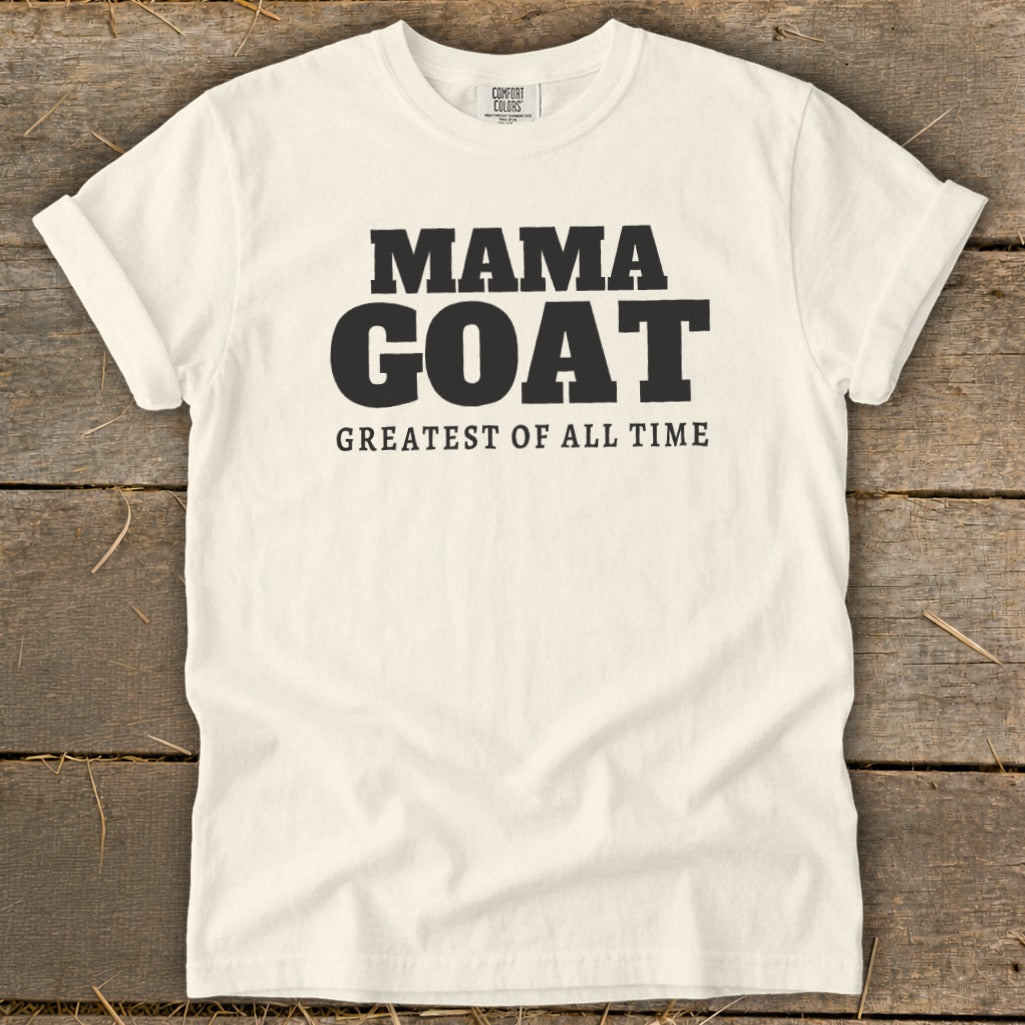 Cream t-shirt with black text reading "MAMA GOAT GREATEST OF ALL TIME."