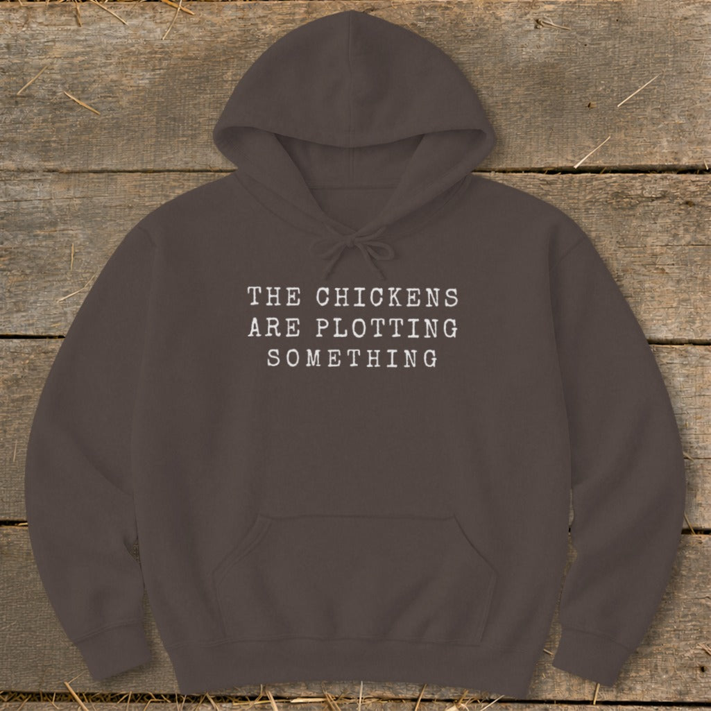 Brown hoodie with "The chickens are plotting something" text.