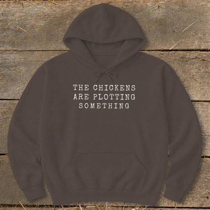 Brown hoodie with "The chickens are plotting something" text.