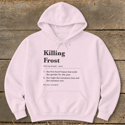Light pink hooded sweatshirt featuring black dictionary-style text defining Killing Frost on a rustic wooden background.