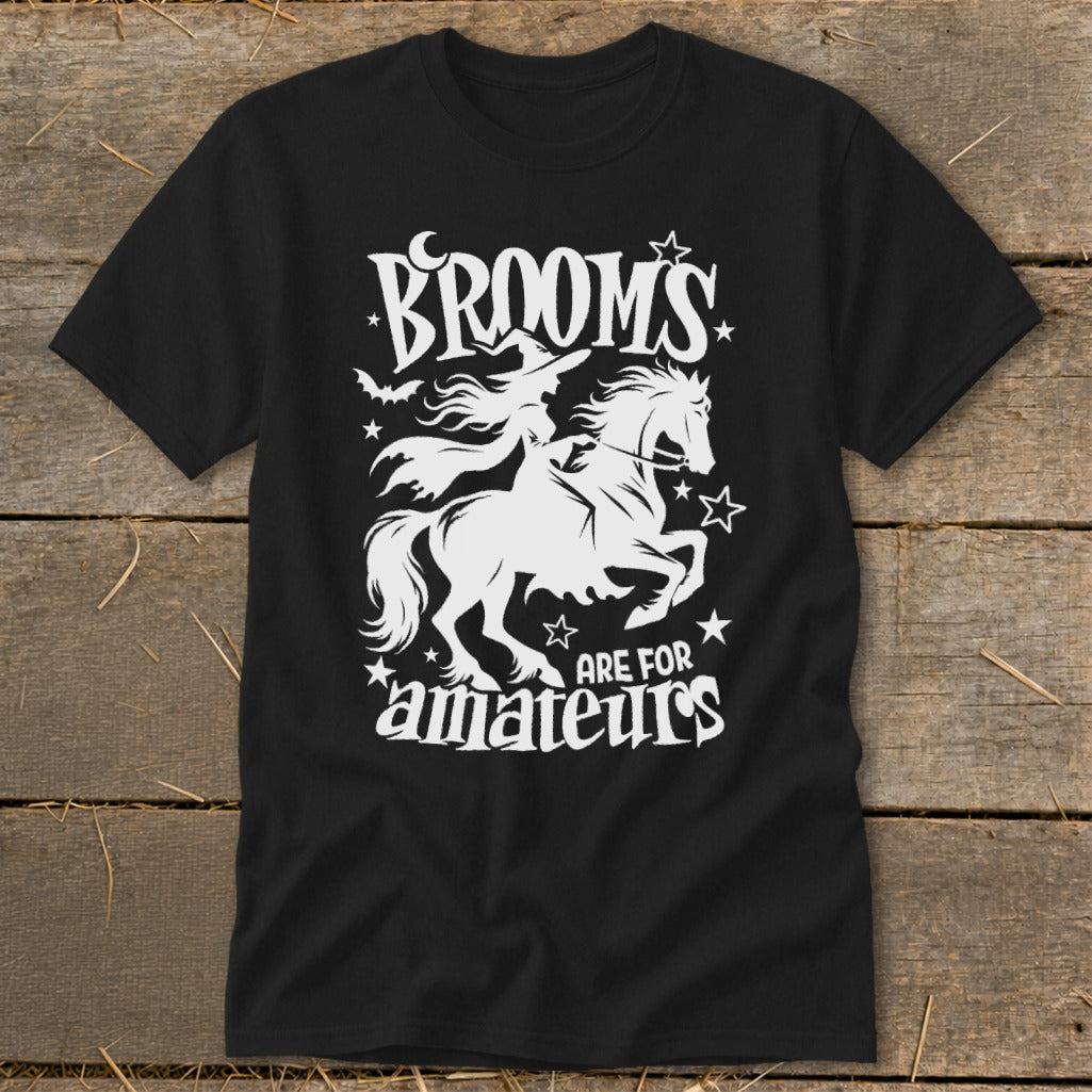 Black t-shirt with white graphic of witch on horse, text reads "Brooms are for amateurs".