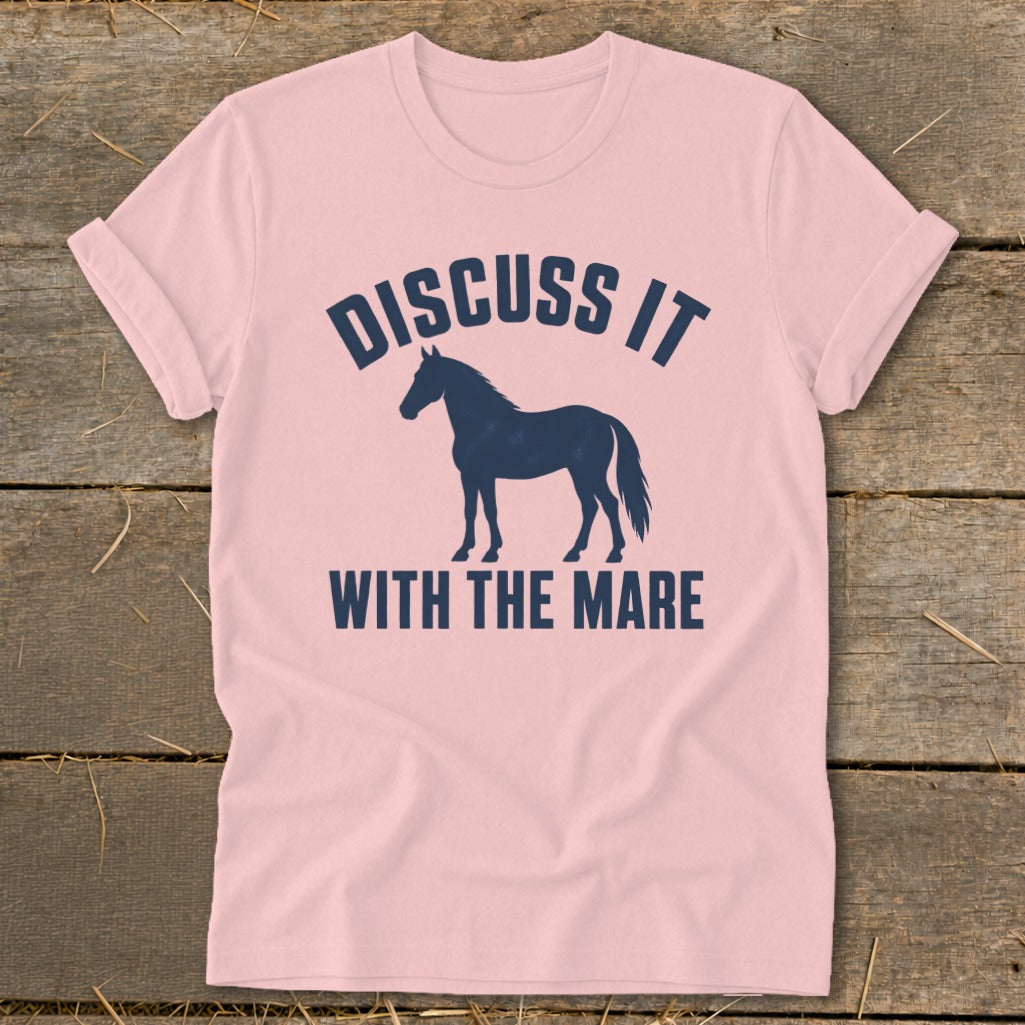 Pink t-shirt with dark blue text "DISCUSS IT" above a horse silhouette and "WITH THE MARE" below.