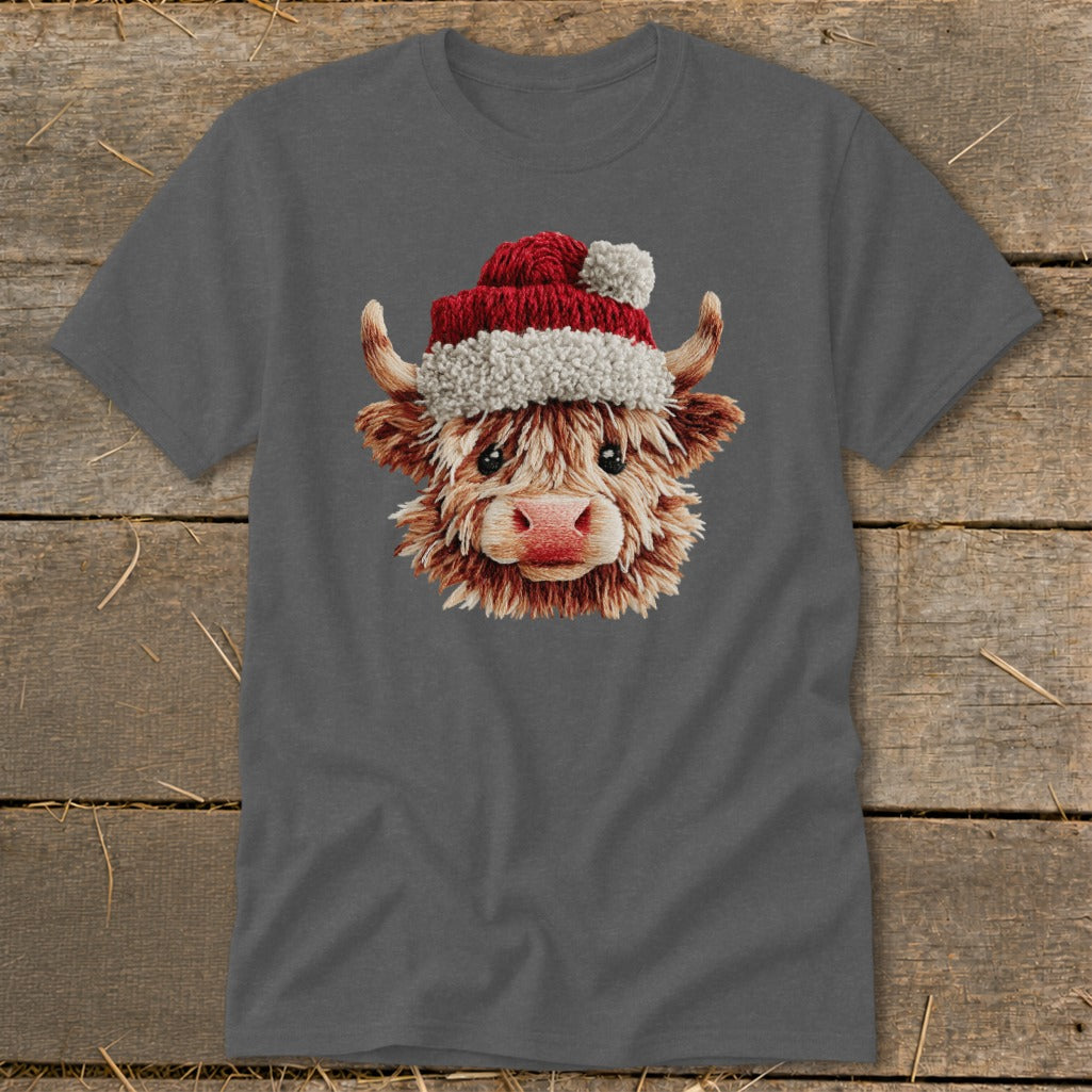 Fluffy Highland cow wearing a Santa hat on a gray t-shirt.