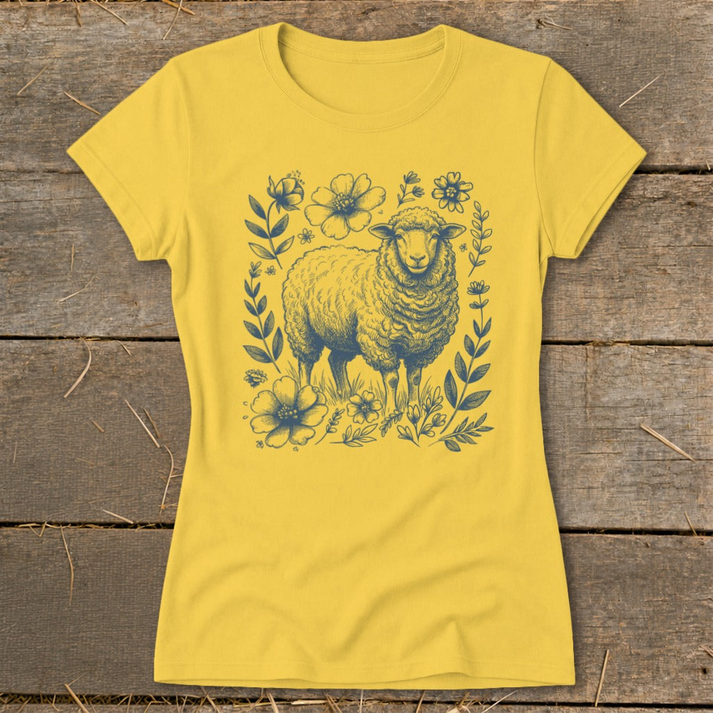 Yellow t-shirt with a navy blue illustration of a sheep surrounded by flowers.