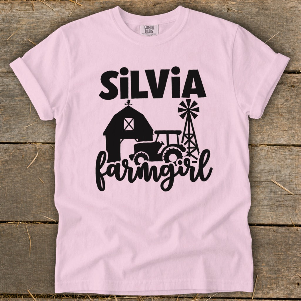 Pink t-shirt with "Silvia" and "farmgirl" text, barn, tractor, and windmill graphic.