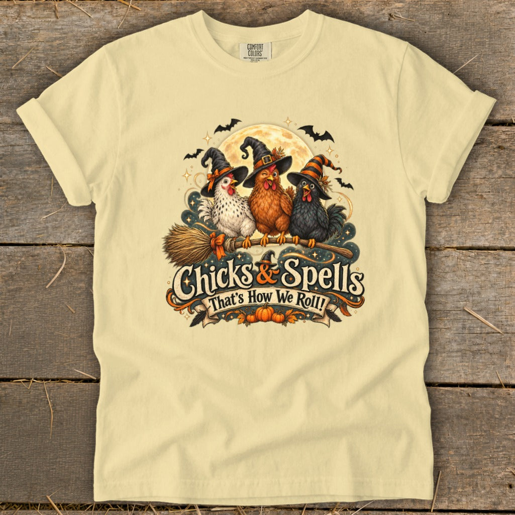 Three chickens in witch hats ride a broomstick with "Chicks & Spells That's How We Roll!" text.