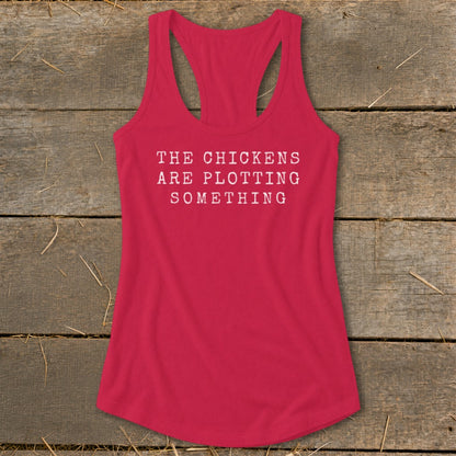 Red racerback tank top with white text "The chickens are plotting something".