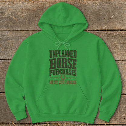 Green hoodie with "Unplanned Horse Purchases Are My Love Language" text and horseshoe.