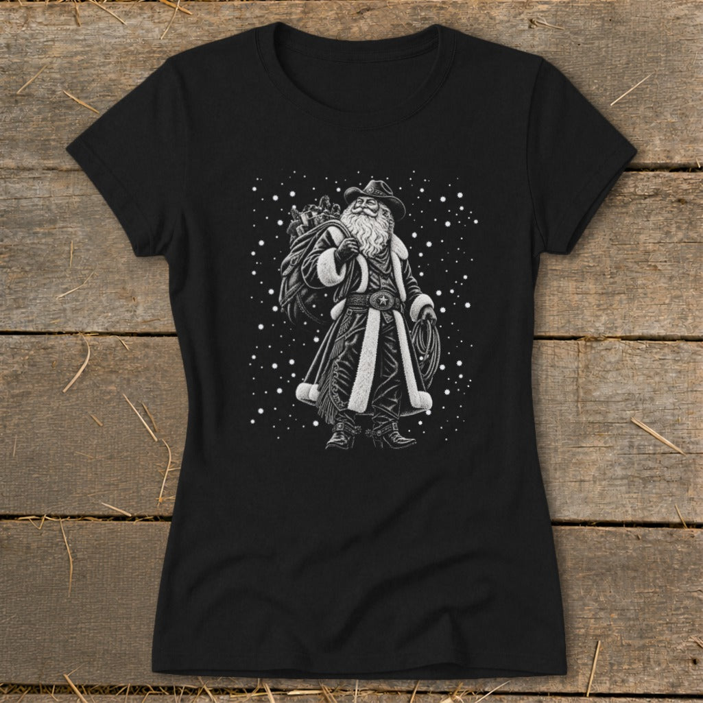 Black t-shirt with a western-themed Santa Claus graphic carrying a sack and lasso.