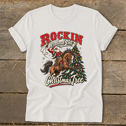 White t-shirt with graphic of Santa on horseback near a Christmas tree, "Rockin' around the Christmas Tree" text.