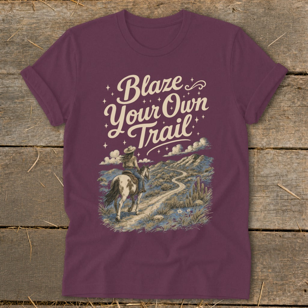 Maroon t-shirt with graphic of person on horseback, text "Blaze Your Own Trail."