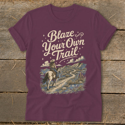 Maroon t-shirt with graphic of person on horseback, text "Blaze Your Own Trail."