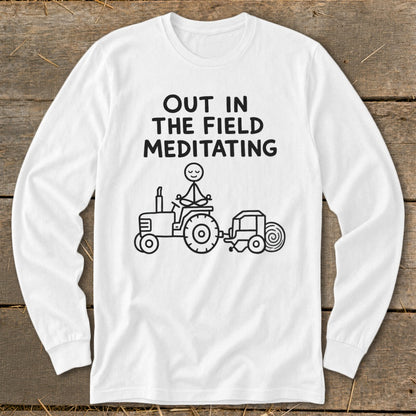 White long-sleeve shirt with text and a drawing of a stick figure meditating on a tractor.