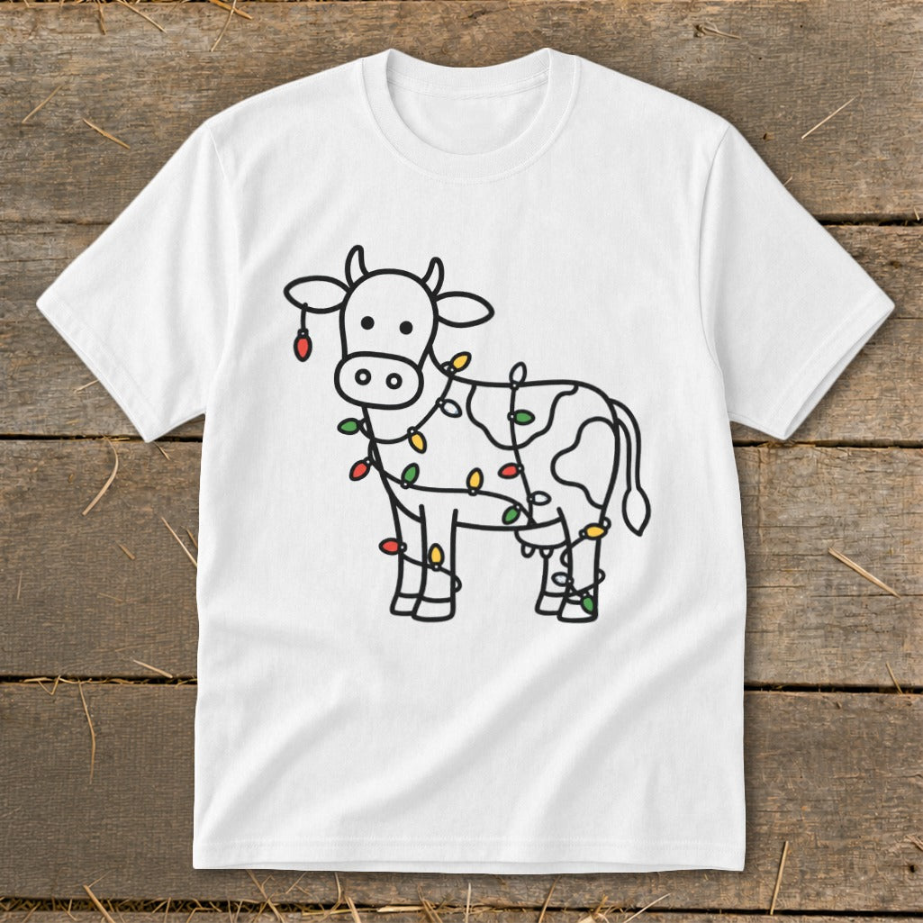 White t-shirt with a black outline drawing of a cow decorated with colorful Christmas lights.
