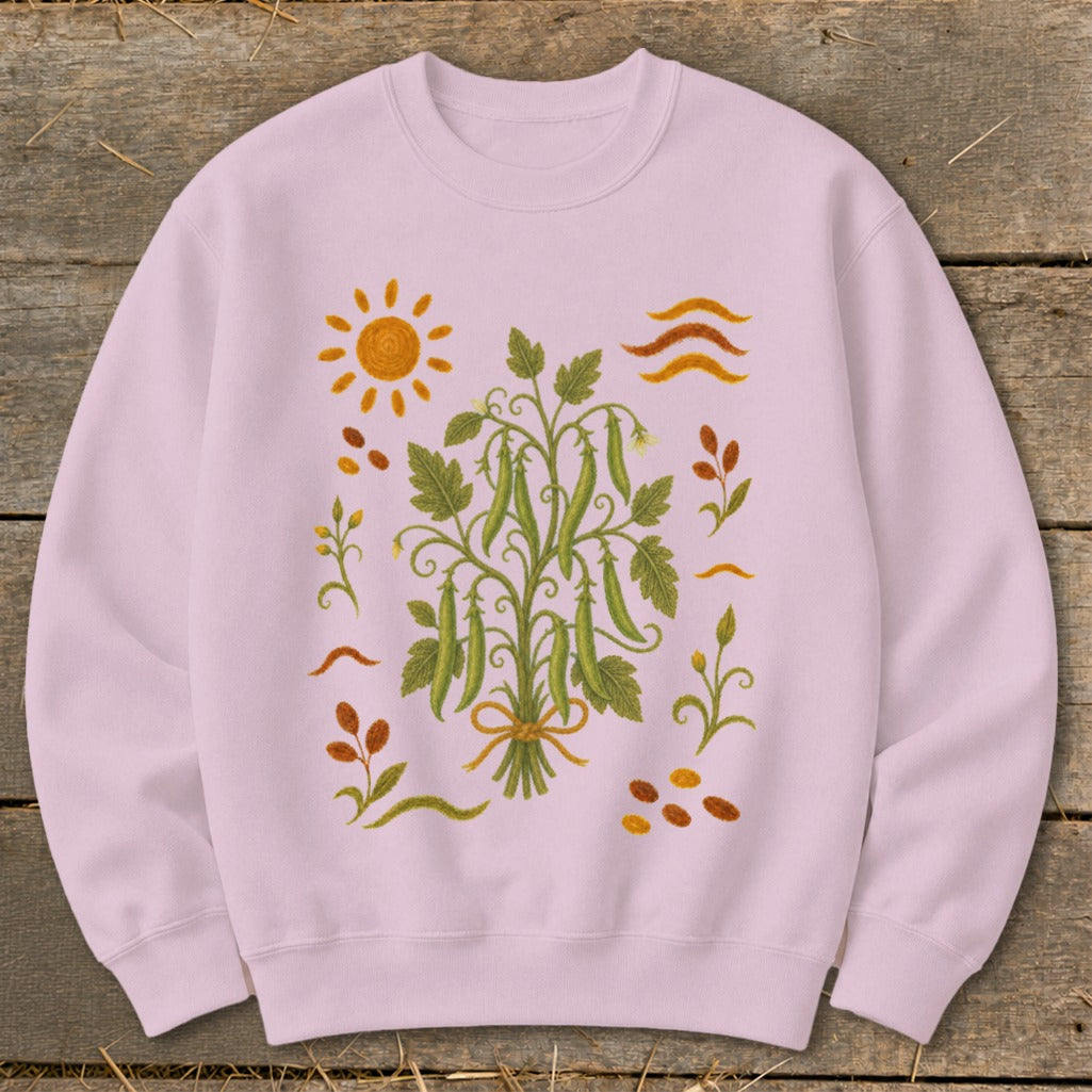 Light pink sweatshirt with a central pea plant illustration and surrounding garden motifs.