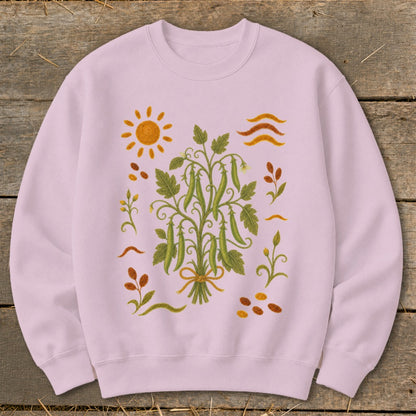 Light pink sweatshirt with a central pea plant illustration and surrounding garden motifs.