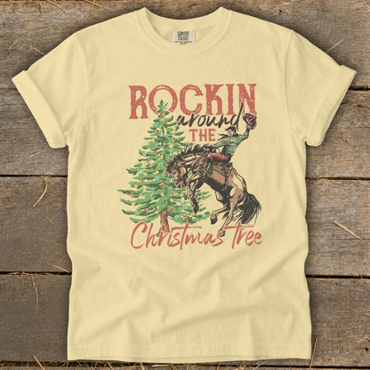 Light yellow t-shirt with "Rockin Around The Christmas Tree" and cowboy graphic.