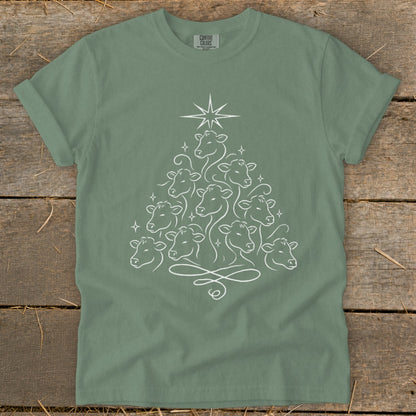 Green t-shirt with a white line drawing of cows forming a Christmas tree with a star on top.