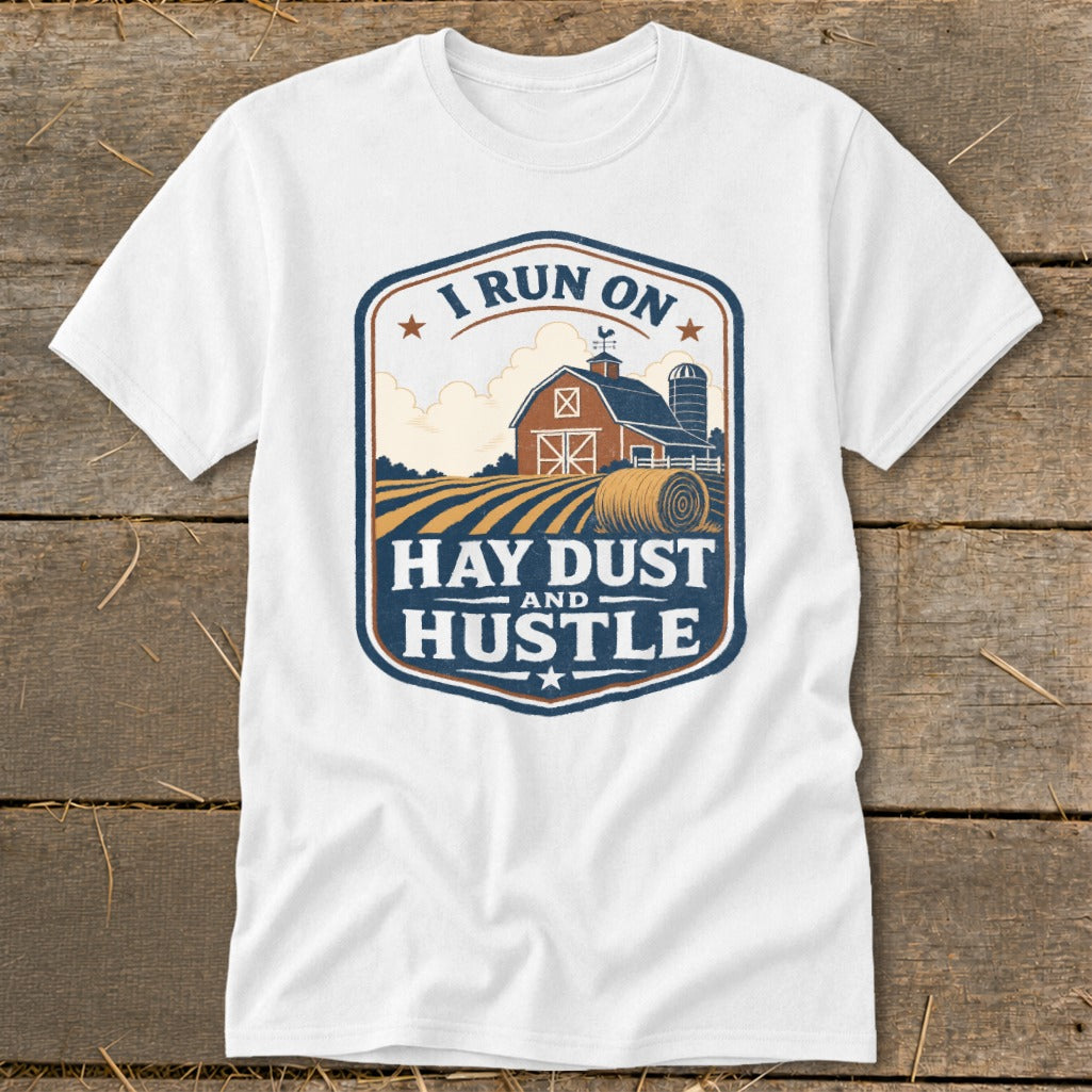 White t-shirt with a farm scene and text "I RUN ON HAY DUST AND HUSTLE".