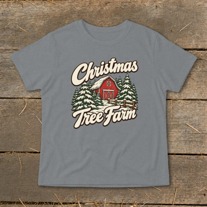 T-shirt with Christmas Tree Farm graphic featuring a red barn and snow-covered pine trees.