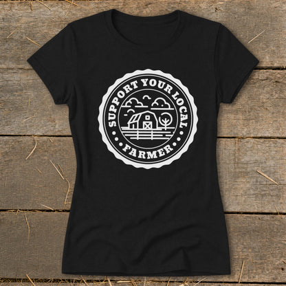 Black t-shirt with circular emblem featuring barn, trees, and text "Support Your Local Farmer".