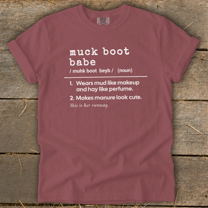 Muck boot babe definition on a maroon t-shirt, includes humorous descriptions.