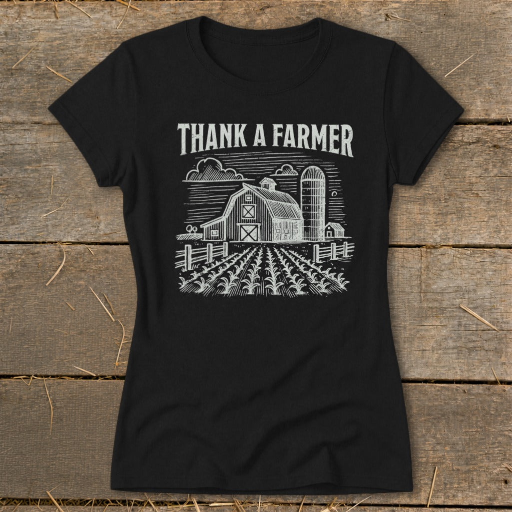 Black t-shirt with "Thank A Farmer" text above a barn and cornfield graphic.