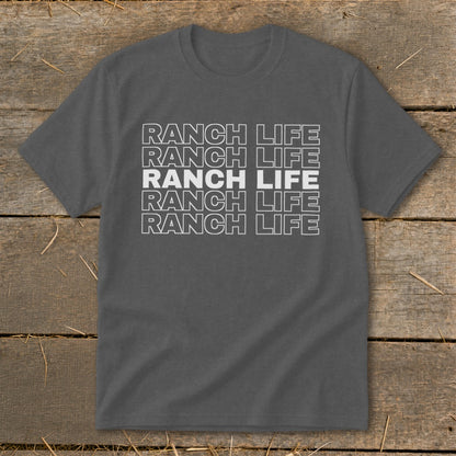 Charcoal gray t-shirt featuring the stacked white text "RANCH LIFE" on a wooden background.