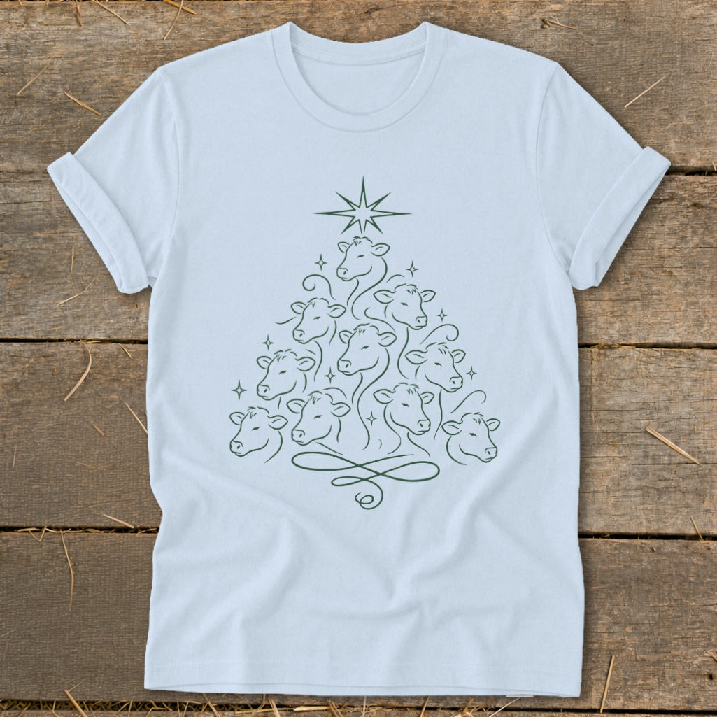 Light blue t-shirt with a Christmas tree made of cow faces and a star.