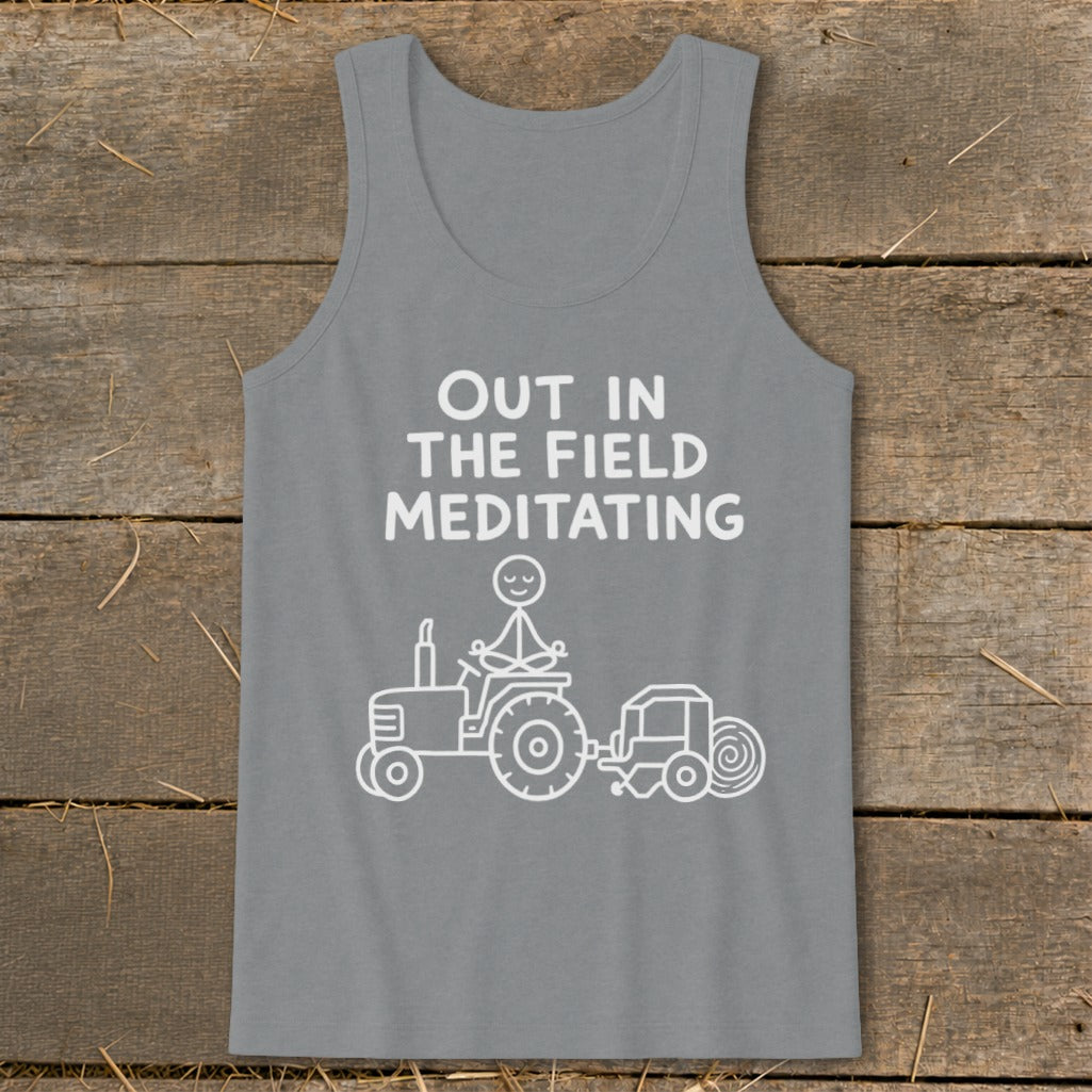Tank top with "Out in the Field Meditating" text and cartoon of a stick figure on a tractor.