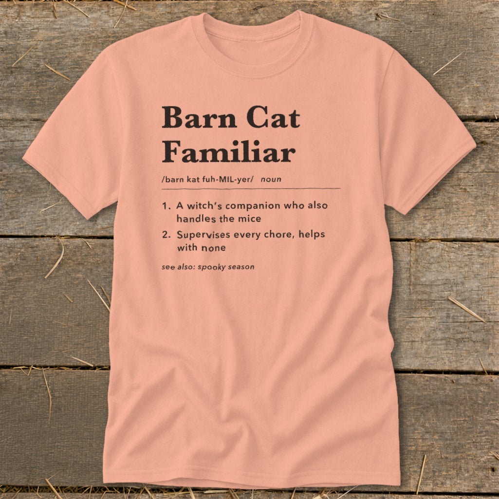 Peach t-shirt with "Barn Cat Familiar" definition: witch's companion, supervises chores.
