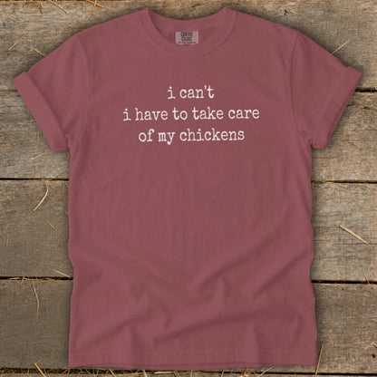 Maroon t-shirt with white text "i can't i have to take care of my chickens".