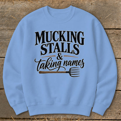 Light blue sweatshirt with "Mucking Stalls & Taking Names" text and pitchfork graphic.