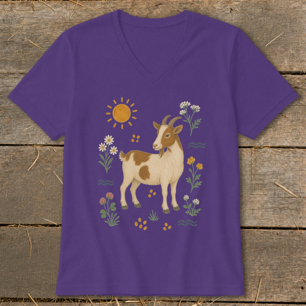 Purple t-shirt with a brown and white goat surrounded by flowers, sun, and wavy lines.