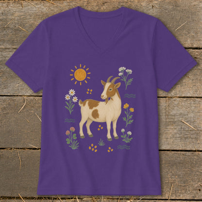 Purple t-shirt with a brown and white goat surrounded by flowers, sun, and wavy lines.