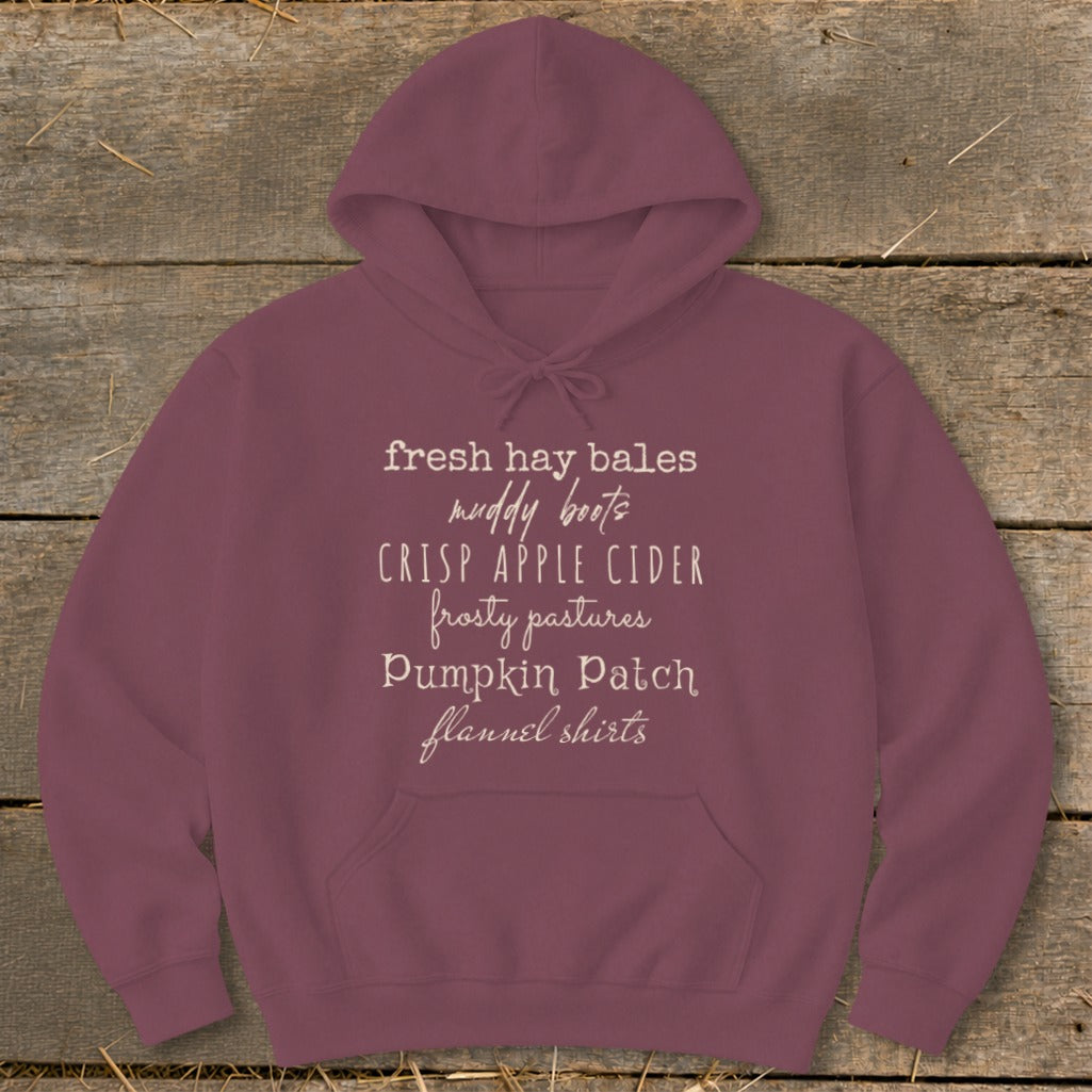 Maroon hoodie with white text listing fall-themed phrases.