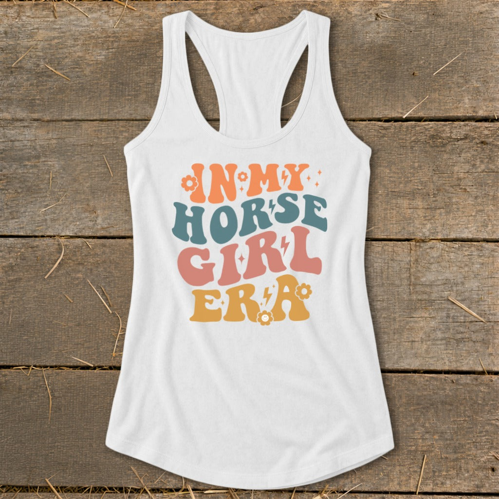 White racerback tank top with "In My Horse Girl Era" text and decorative elements.