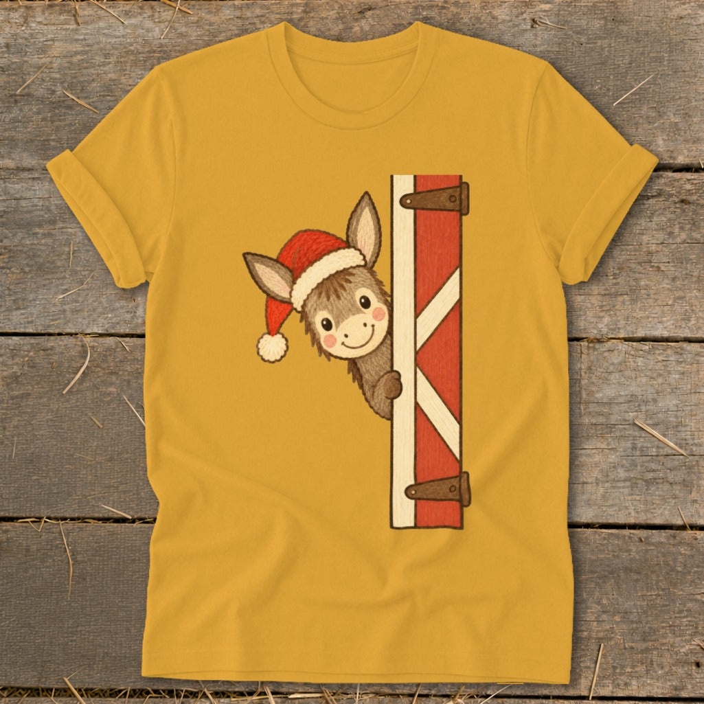 Yellow t-shirt with a cartoon donkey wearing a Santa hat peeking from behind a red barn door.