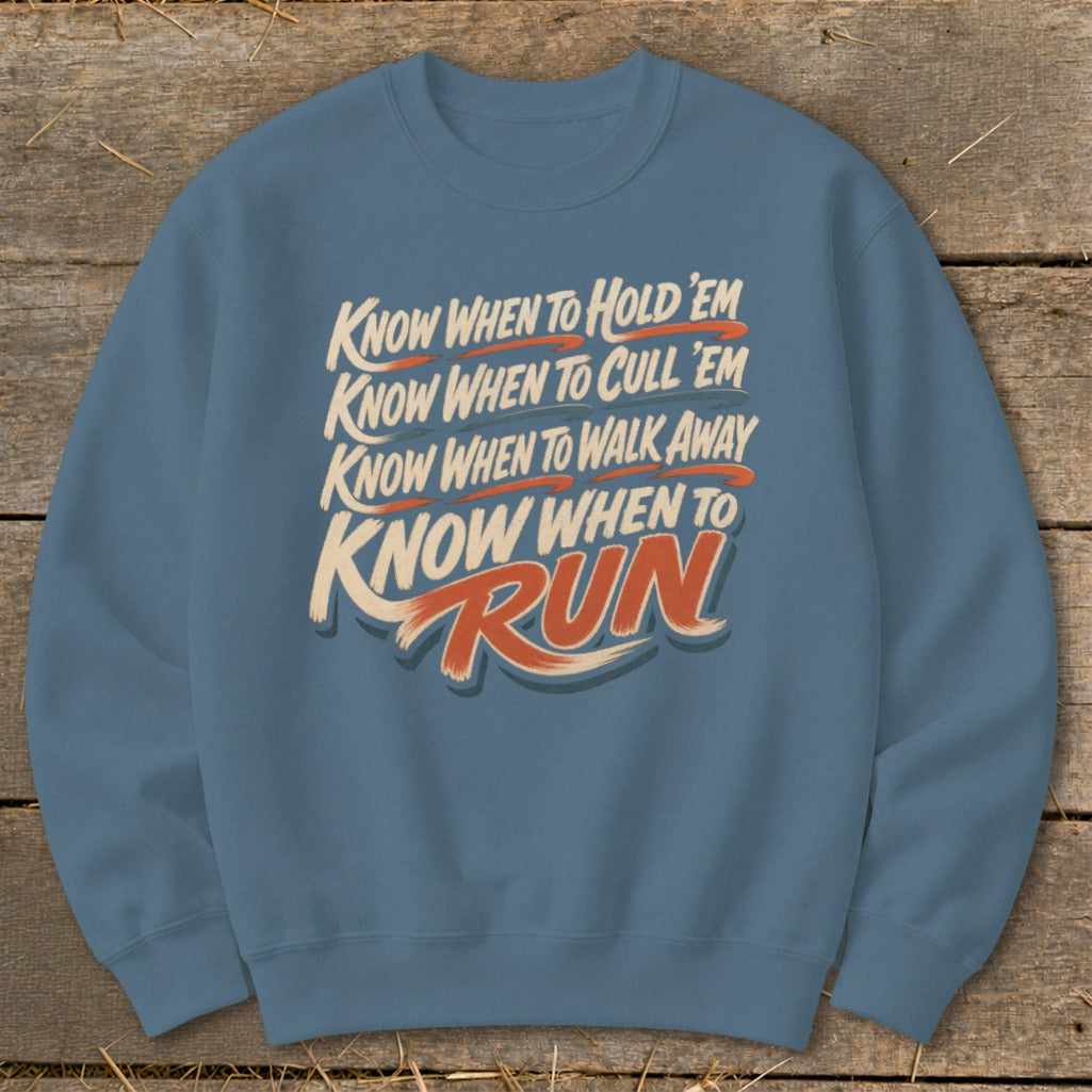 Blue sweatshirt with text: "Know When to Hold 'Em, Cull 'Em, Walk Away, and Run."