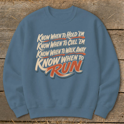 Blue sweatshirt with text: "Know When to Hold 'Em, Cull 'Em, Walk Away, and Run."