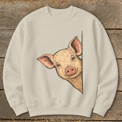 Cream sweatshirt with a sketch of a pig peeking around a corner.