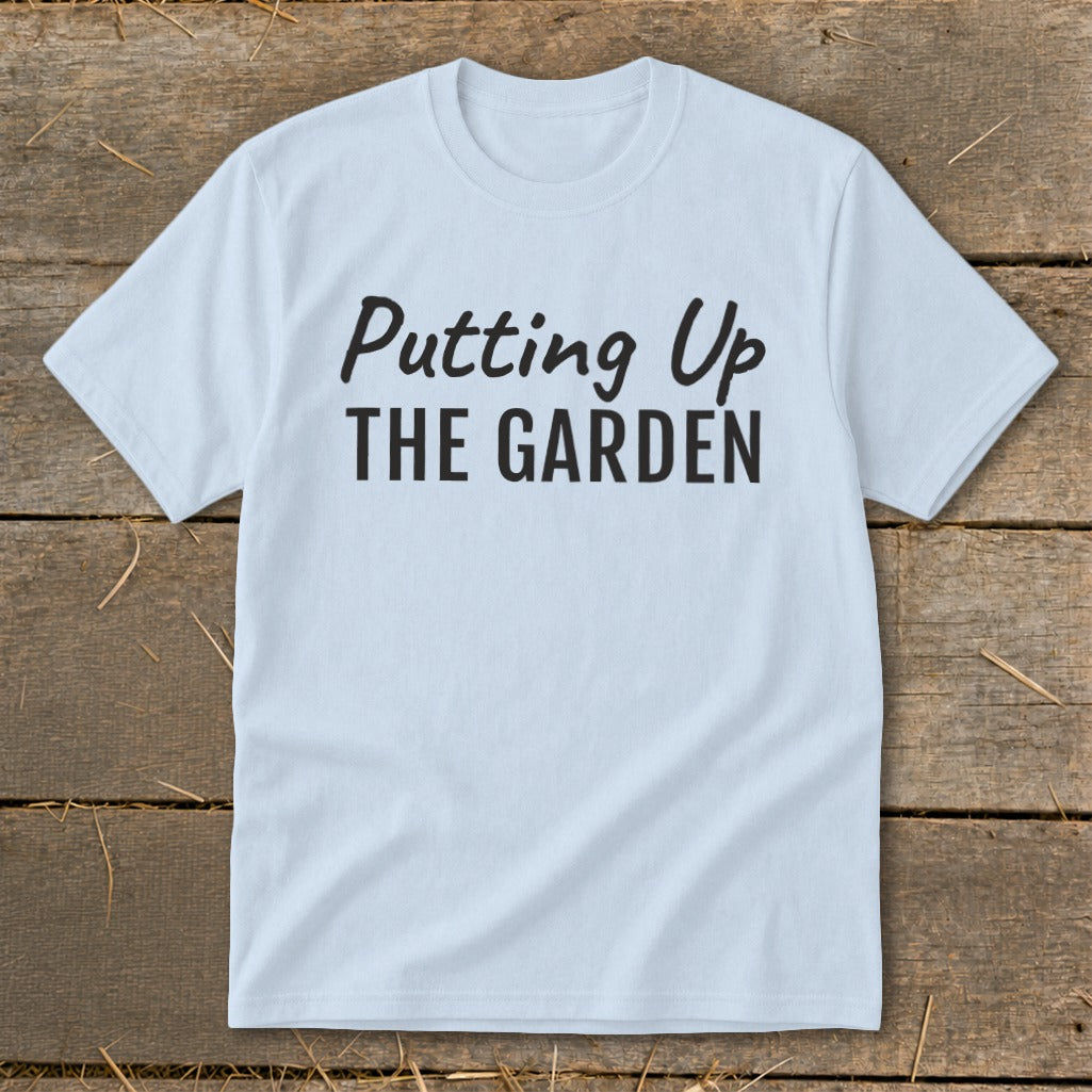 Light blue t-shirt with black text "Putting Up THE GARDEN".