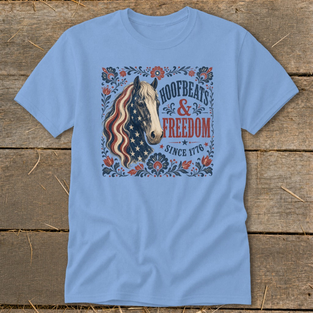 Blue t-shirt with a horse graphic featuring an American flag mane and text "Hoofbeats & Freedom Since 1776".
